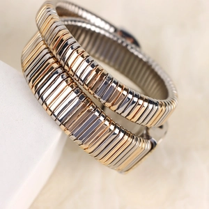 Elegant two-tone and silver snake-style Tubogas flexible watch bands on display