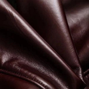 Macro shot of deep burgundy faux leather texture with soft luster and fine grain details