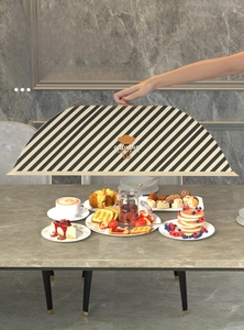 Detail of a large foldable food cover with Nordic black and white stripes on a dining table