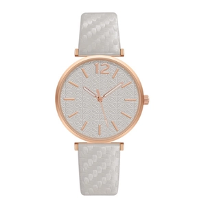 Detail of rose gold watch dial with leaf texture and white woven strap