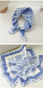 Detail of blue and white floral cotton linen scarf with knotted style and pattern view