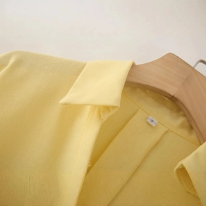 Women's light yellow linen blend V-neck shirt with wide sleeves and woven texture detail