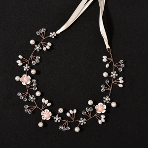 Detailed view of handmade bridal headband with pearls, crystals, and delicate flowers