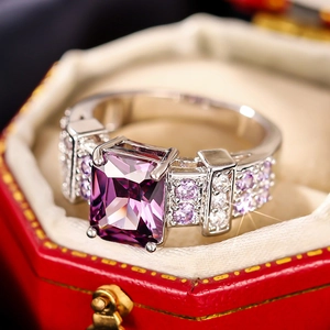 Macro view of a square purple gemstone ring with four-prong setting and side micro-paving