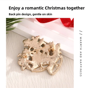 Detail view of the secure safety pin clasp on gold metal Christmas brooch
