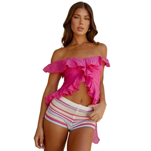 Sexy hot pink ruffled off-shoulder top with colorful striped crochet knit shorts