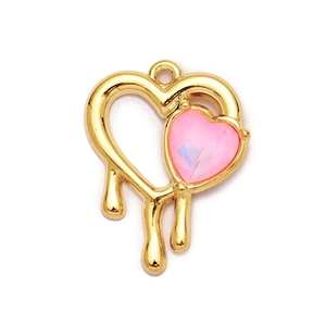 Close-up of pink heart gemstone on a gold-plated molten texture metal pendant