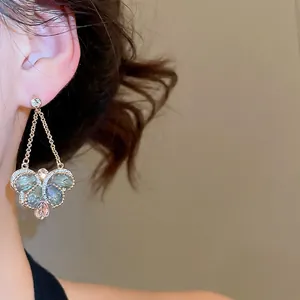 Vintage gold butterfly drop earrings with grey-green gemstones and sparkling crystals