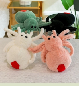 Detail of plush spider toys in green, black, white, and pink with red heart patterns