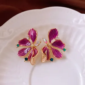 Exquisite purple enamel flower earrings with sparkling zircons and green crystal accents