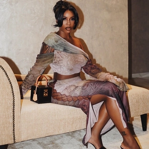 Women's 2-piece mesh suit featuring a purple floral print crop top and high slit skirt