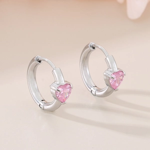 Close-up of heart-shaped pink crystal earrings in polished silver stainless steel