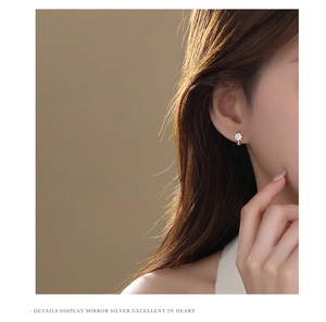 Close-up of minimalist S925 sterling silver earring with a sparkling cubic zirconia stone