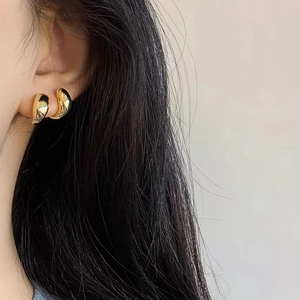 Minimalist 925 silver needle golden teardrop bean earrings shown on a model