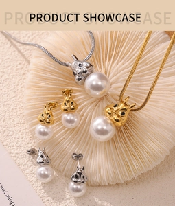 Close-up of cute rabbit jewelry set with white pearls and 18k gold plating on a coral tray