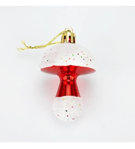 Detail of red and white mushroom Christmas ornament with glitter and gold hanging string