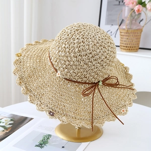 Women's foldable straw sun hat with bow tie, scalloped edge and floral accents