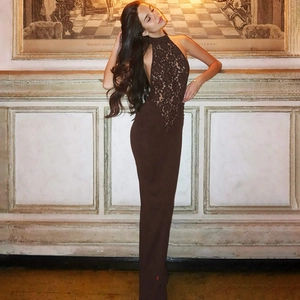 Detail of the plunging V-neck lace bodice and halter neck on a backless brown maxi dress