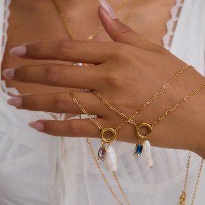 Detail of 18K gold stainless steel necklaces with freshwater pearls and colorful gemstones