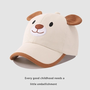 Detailed close-up of cute cartoon bear embroidery on off-white kids baseball cap