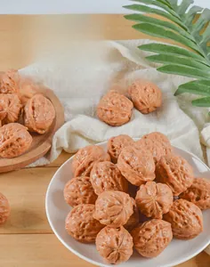 Detailed macro of artificial PVC walnuts showing realistic shell texture in a white dish