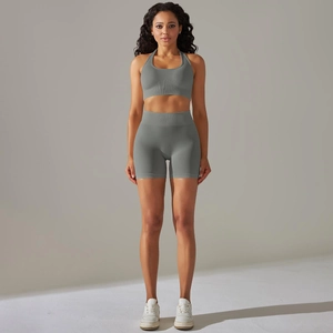 Detail of grey seamless yoga set featuring halter sports bra and high waist biker shorts