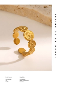 Macro detail of gold vintage sunburst medallion open ring on natural stone display