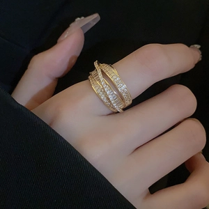 Detailed view of layered gold ring with micro-pave cubic zirconia on a model's finger