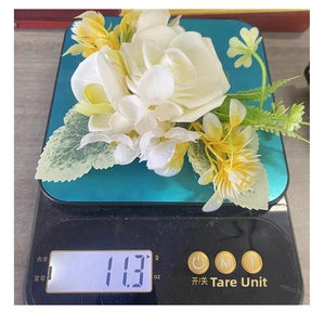 Detailed view of handmade white rose flower accessory on scale weighing 11.3 grams