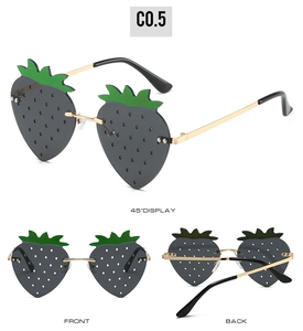 Three-angle views of strawberry-shaped sunglasses with gray lenses and gold metal frames