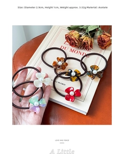 Close-up of acetic acid flower hair tie with pearl center and elegant texture details