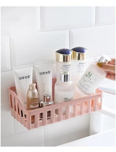Pink rectangular wall-mounted storage basket with hollow design for bathroom organization