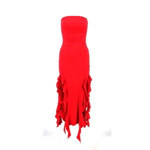 Detail of red tube dress featuring ruching and dramatic ruffled fishtail hemline