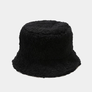 Detailed texture of thick black faux sheepskin fleece on a warm winter bucket hat
