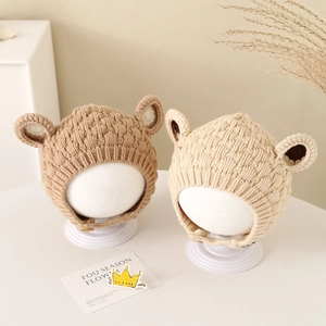 Winter knitted baby earflap hat with cute animal ears and warm plush lining in brown and beige