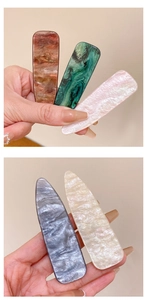 Detailed close-up of marble pattern acetate hair clips in rectangular and drop shapes