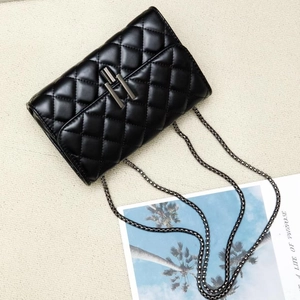 Chic black quilted crossbody bag with gunmetal chain strap and sleek turn-lock closure
