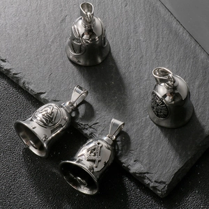 Detailed view of four stainless steel motorcycle guardian bells with embossed symbols