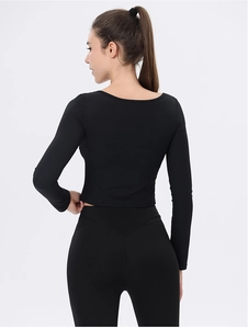 Rückansicht eines schwarzen gerippten Yoga-Langarmshirts und Leggings am Model