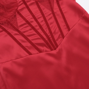 Detail of red backless dress showing satin fabric and intricate lace embroidery