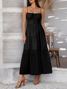 Detail view of high waist black tiered maxi dress with thin straps for elegant evening events