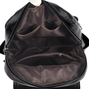 Internal structure of black leather backpack with open pockets and zippered compartment