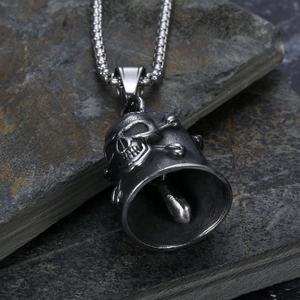 Retro stainless steel skull bell guardian pendant for motorcycle riders on stone background