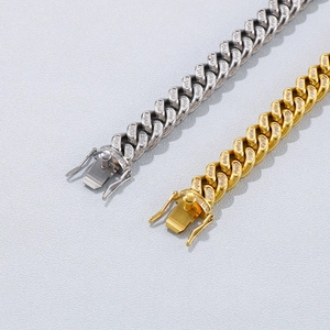 Close-up of gold and silver hip hop Cuban link bracelets with iced out CNC diamonds