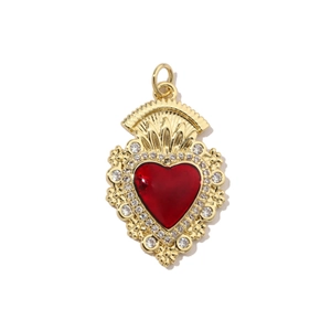 Detail showing a vibrant red heart pendant with gold plating and cubic zirconia inlay
