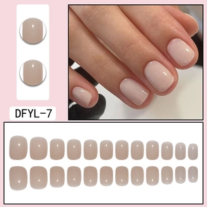 Detail of short square nude pink glossy press-on nails set with 24 pieces in various sizes