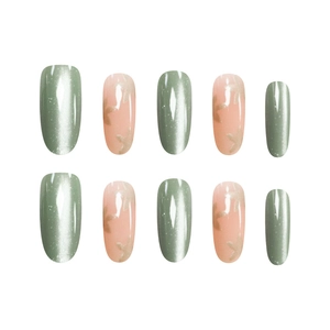 Short oval press-on nails featuring green cat-eye glitter and translucent pink with gold stars
