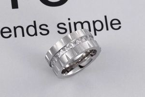 Detailed macro view of wide matte titanium steel ring with inlaid square cubic zirconia