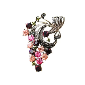 Detailed macro view of vintage flower brooch featuring colorful gemstones and alloy setting