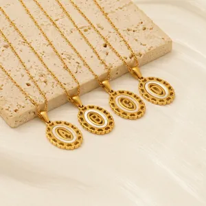 Gold titanium steel necklaces with oval alphabet pendants A-D on elegant satin background